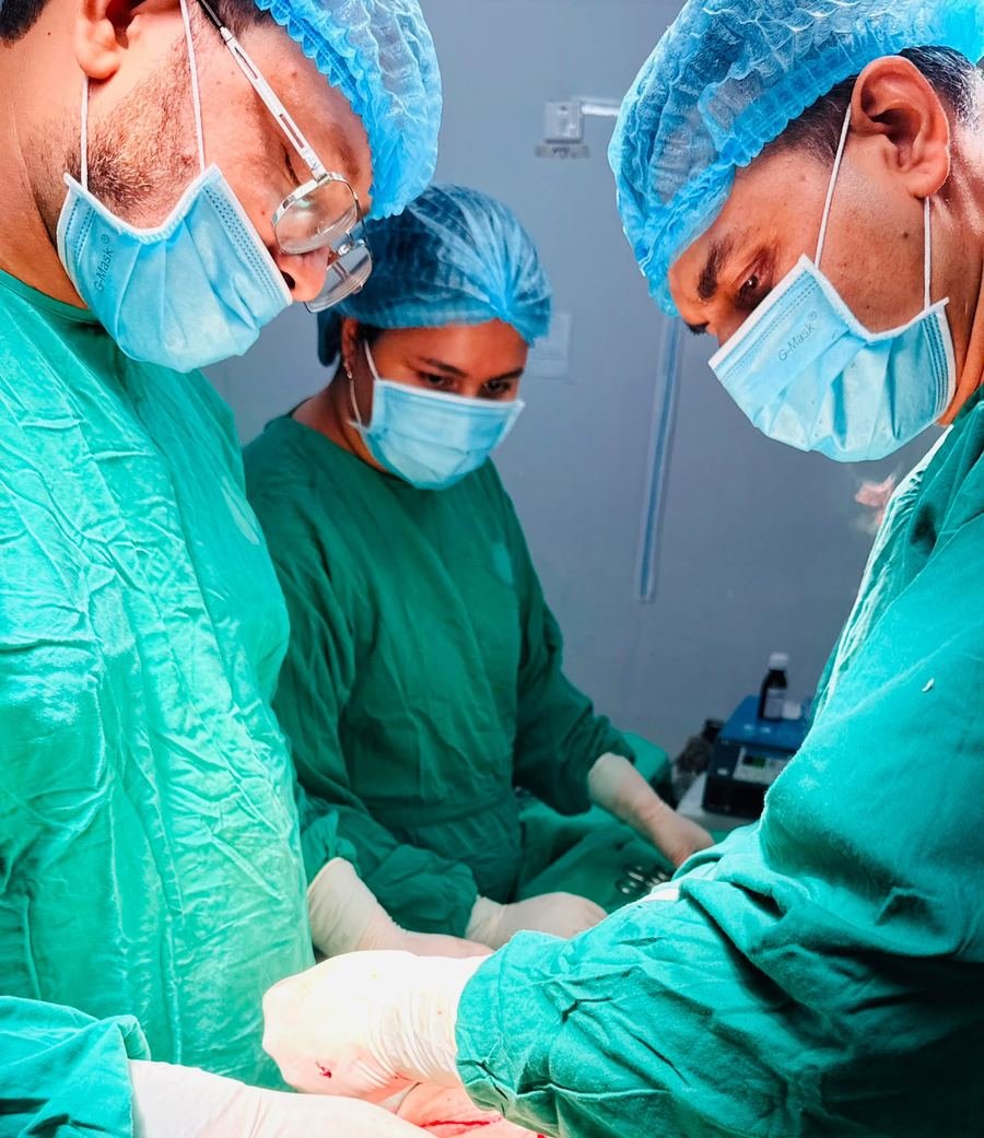 Dr. Maksudur Rahman operating with his surgical team